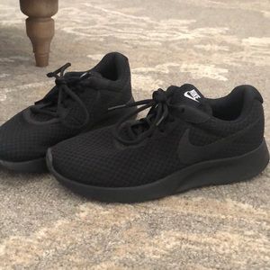 All black Nike athletic shoes